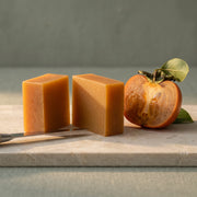 The bar cut in half beside a persimmon