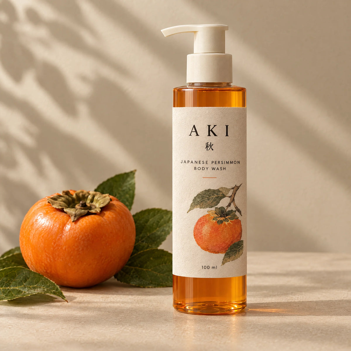 The Wash, 100 ml pump bottle, beside a persimmon